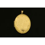 A large 9 ct gold foliate engraved locket, 35.9 grams, 54 mm x 47 mm.