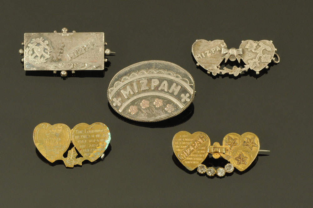 A collection of three silver and two plated Mizpah brooches.