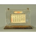 A silver mounted desk calendar Birmingham hallmark 1931. Width 15 cm.