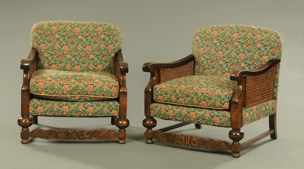 A pair of 1920's stained beech bergere armchairs, with double caned sides,