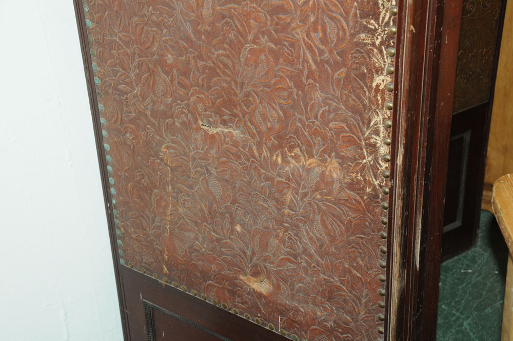 A massive mahogany four fold screen, with gilt embossed cloth panels. - Image 7 of 10