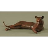 A bronze model of a recumbent cat. Length 29.5 cm.