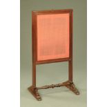 A Victorian mahogany fire screen, with lift up slide and turned low stretcher.