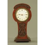 An Art Nouveau mahogany cased mantle clock, with single train movement. Height 27 cm, width 13 cm.