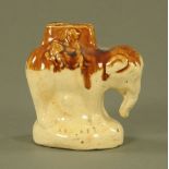 A 19th century earthenware elephant form money box, stamped "Save All". Height 11 cm.