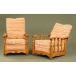 A pair of 1930's oak recliner armchairs, with slatted sides on turned front supports.