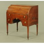 A Regency mahogany cylinder bureau, the long drawer opening and operating the roll,