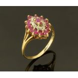 A gold coloured metal ruby and diamond cluster ring, Size P.