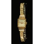 An 18 ct gold cased ladies wristwatch by Mithra, with expanding plated bracelet.