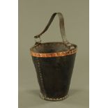 A 19th century black leather and copper rimmed fire bucket, 28 cm high, 28 cm diameter.