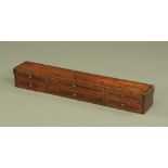 A 19th century inlaid mahogany and rosewood banded tabletop bank of drawers. Height 12.