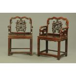 A pair of Chinese hardwood armchairs, with pierced splat backs,