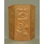 An early 20th century copper folding three panel fire screen, embossed with sunflowers.