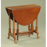 A mahogany Sutherland table, 1930's with demi lune flaps, turned columns and cabriole type legs.