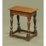 A 17th century oak rectangular joint stool with baluster turned supports and low stretchers,