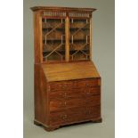 A Georgian mahogany bureau bookcase. Height 213 cm, width 122 cm, depth 55 cm.