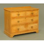 A late Victorian light oak chest of drawers of Arts and Crafts design.