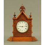 A late Victorian Gothic walnut mantle clock, with single train movement. Height 27 cm, width 22 cm.