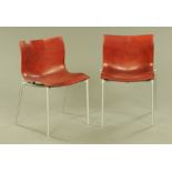 A pair of Philip Starck red plastic and aluminium Cam El Eon chairs by Driade.