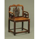 A Chinese hardwood open armchair, with carved splat,