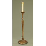 A walnut lamp standard, with candle top and fluted and carved column with circular base.