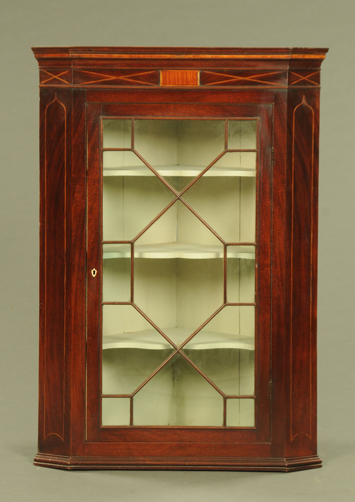 A George III inlaid mahogany hanging corner cupboard, with glazed door,