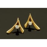 A pair of 18 ct white and yellow gold rubover set earrings, set with diamonds weighing +/- .