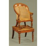 A 19th century child's mahogany bergere chair with stand.