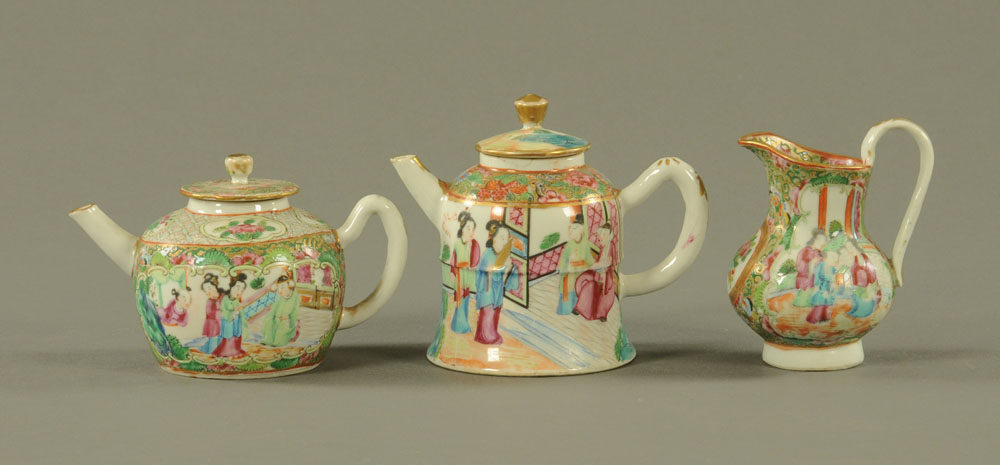 Two Chinese Cantonese teapots, of small form together with a similar jug. Tallest 12 cm.