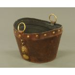 A 19th century brown leather and brass studded oval bucket, 25 cm high, 35 cm long.