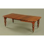 A Victorian mahogany extending dining table with three leaves,
