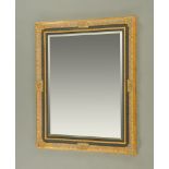 A gilt and painted rectangular mirror, with bevelled glass. 102 cm x 126 cm.