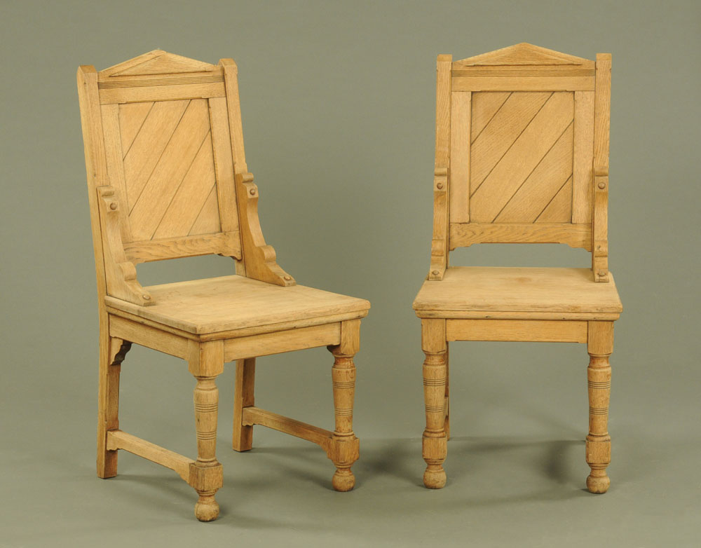 A pair of heavy bleached oak panel backed hall chairs.