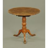 A 19th century oak tripod occasional table, with snap action and three downswept legs.