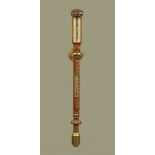 A marine barometer, in the Regency style, mahogany with twist case and complete with brass gimbal.