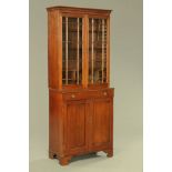 A 19th century mahogany bookcase on cupboard, with glazed panelled doors to the upper section,