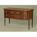 A Regency mahogany sideboard, bow fronted and ebony strung and raised on turned tapered legs.