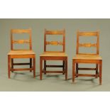 A set of three early 19th century mahogany bar back dining chairs with carved splats and plain