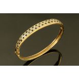 A 9 ct gold sapphire and diamond bangle, internal width 58 mm. Height 48 mm.