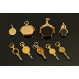 Three 9 ct gold mounted swivel fobs, a 9 ct gold pendant inscribed M together with five watch keys.