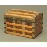 A late Victorian brown cloth and wood bound domed top travelling trunk.