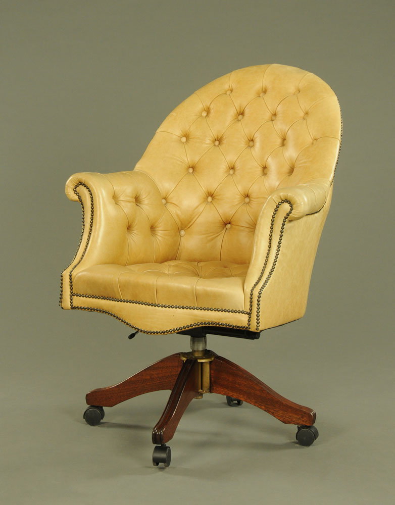 A Victorian style deep buttoned beige leather revolving desk chair,