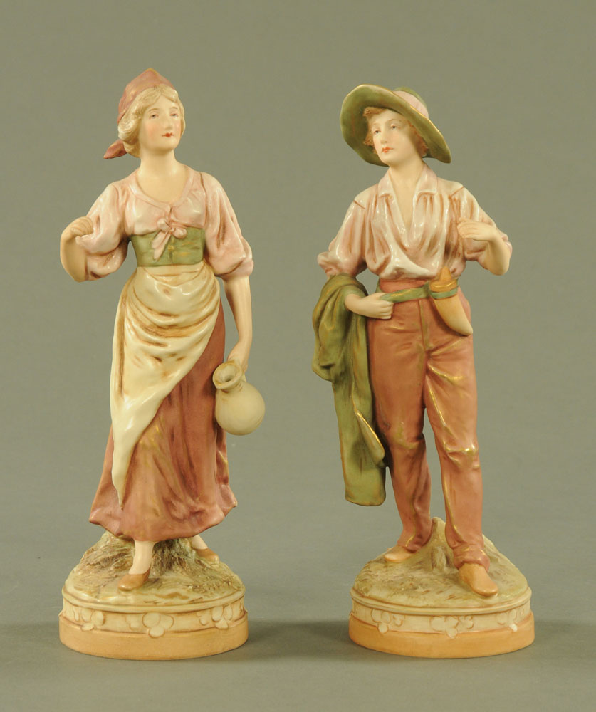 A pair of Royal Dux figures, boy and girl,