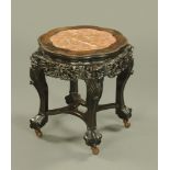 A 19th century Chinese hardwood rouge marble topped jardiniere stand, raised on later castors.