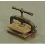 A Victorian cast iron book press, of typical form. Width 41 cm.