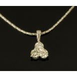 An 18 ct white gold trefoil pendant on chain, set with diamonds weighing +/- .60 carats.