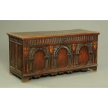 A large 18th century oak coffer, with planked top with moulded edge,