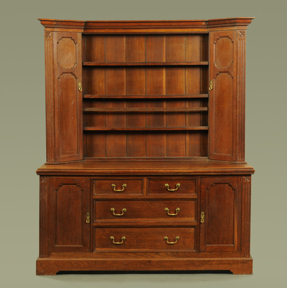 A late Victorian oak dresser with Delft rack above,