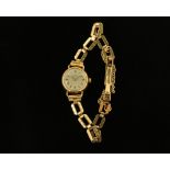 A 9 ct gold cased ladies Omega wristwatch, manual with 9 ct gold bracelet. Gross weight 11.6 grams.