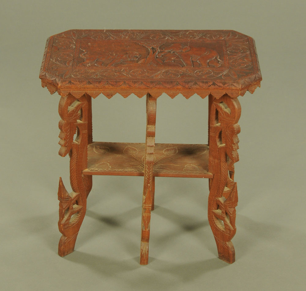 An Indian carved wooden occasional table, carved with an elephant and tiger.